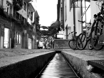 A road with bikes next to a water channel.