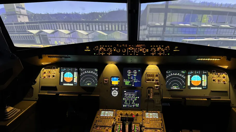 Airplane cockpit with digital displays, view outside.