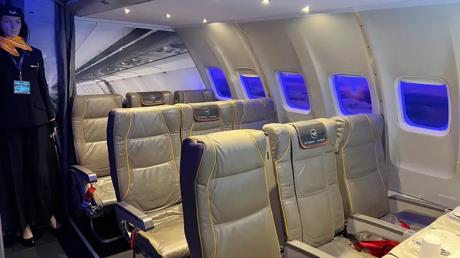 Airplane cabin with mannequin in uniform.