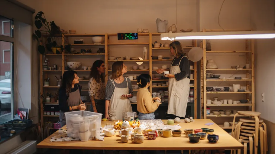 Group in pottery class, discussing ceramics.