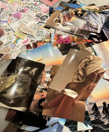 Sammlung von Fotos und motivierenden Stickern auf Tisch.