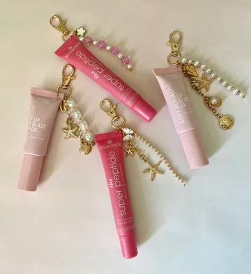Lip gloss tubes with decorative keychains.
