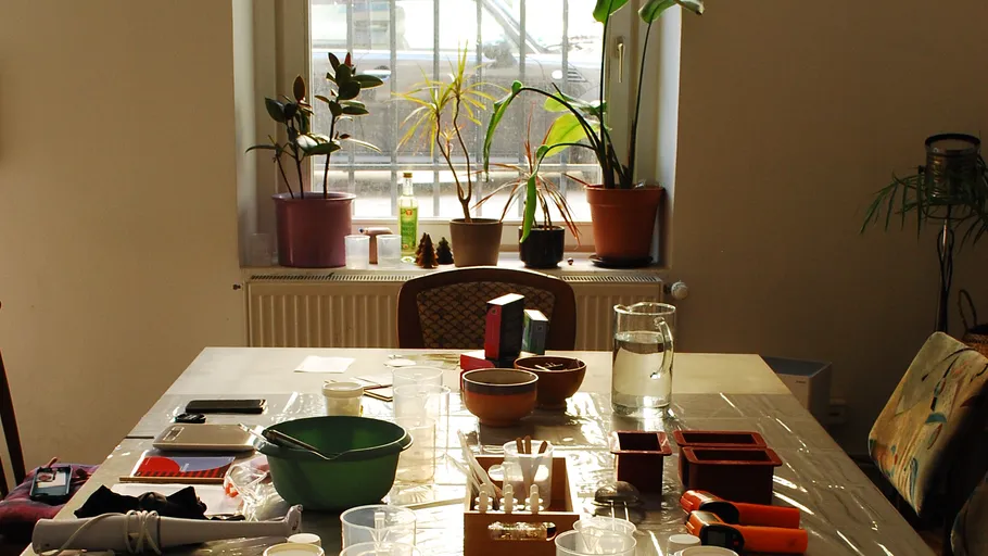 Table with plants and craft supplies.