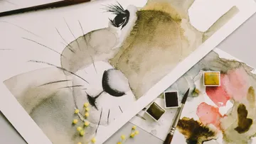 Aquarellgemälde eines Löwen mit Pinseln.