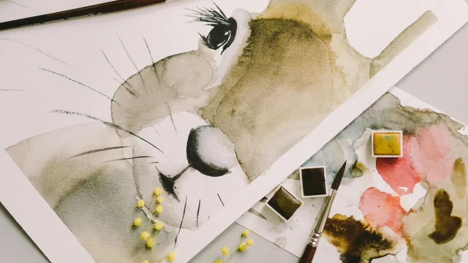 Watercolor painting of a lion with paintbrushes.