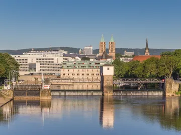City view with waterway and historic buildings in the background.