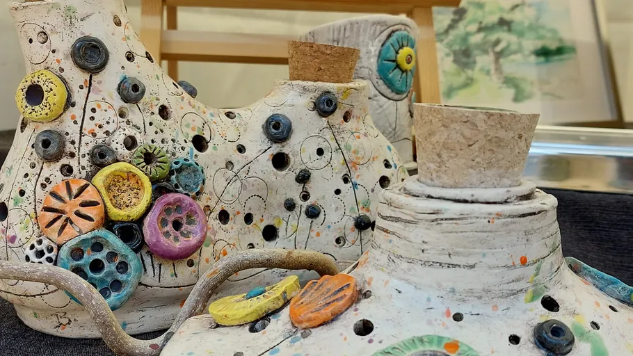 Colorful ceramic pieces with corks and decorations.