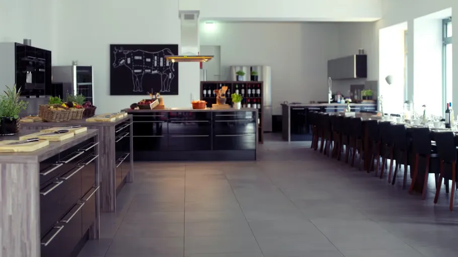 Modern kitchen with dining area, well-lit space.