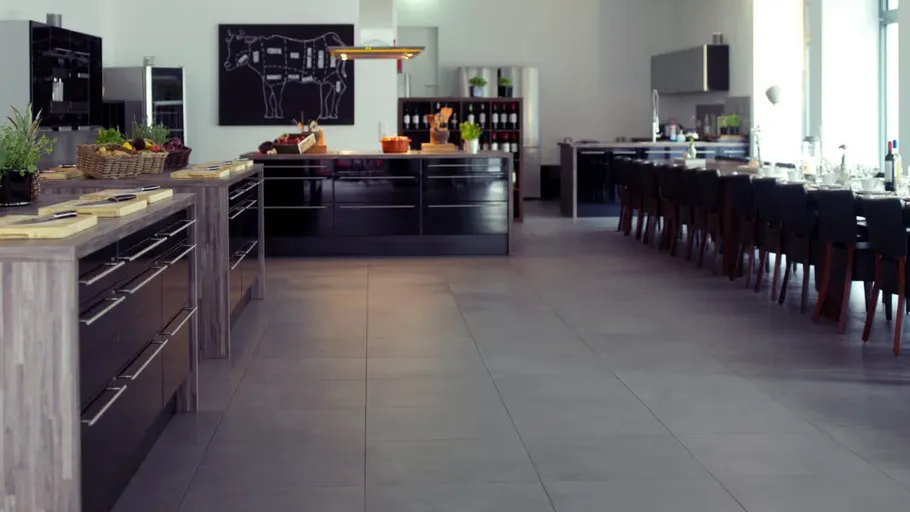 Modern kitchen with island and dining tables.
