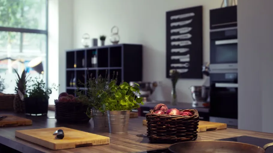 Modern kitchen with plants and cutting boards.
