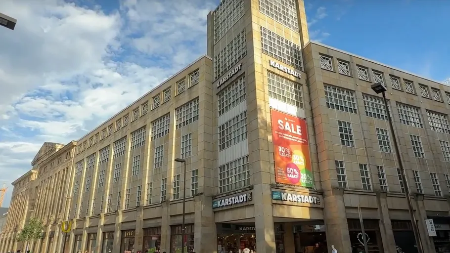 Department store with a sale banner in city.