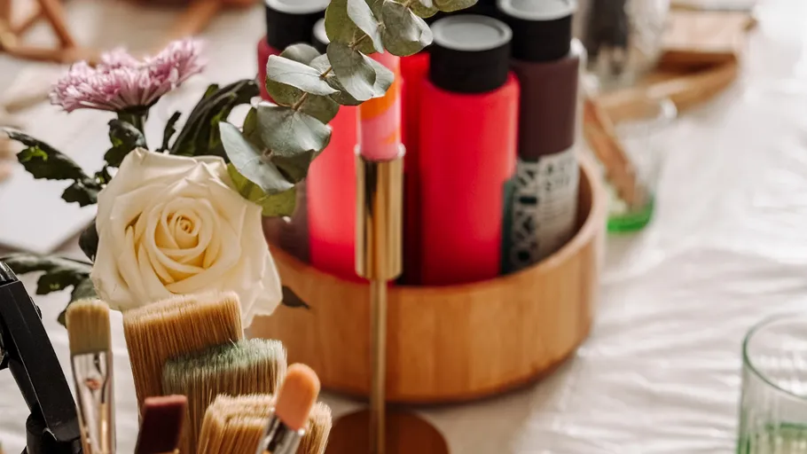 Art supplies and flowers on a table.