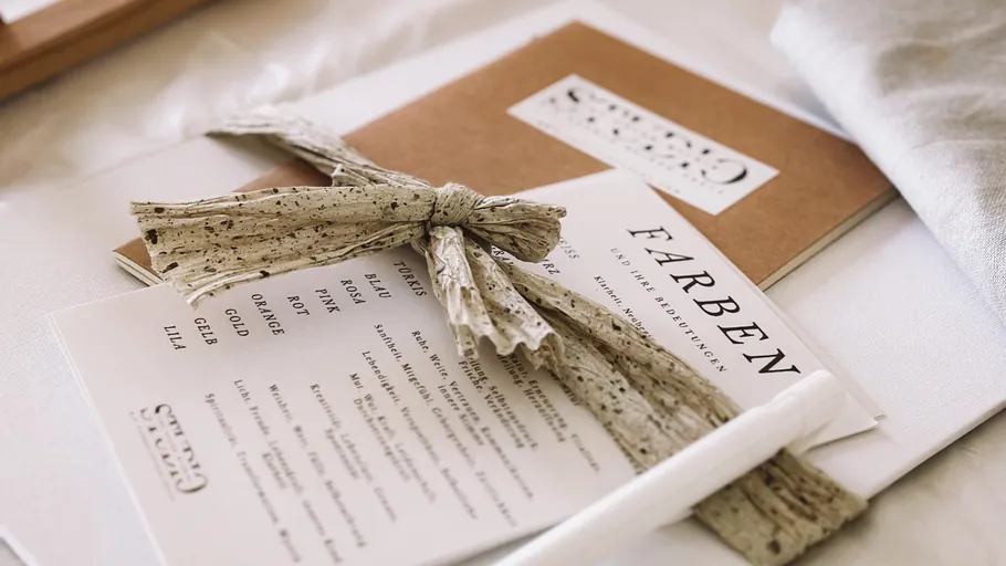 Decorative paper with bow, pen, notebook.