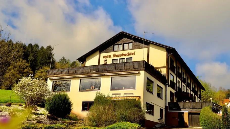 Hotel building surrounded by lush greenery.
