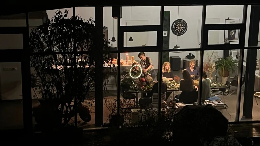 People dining indoors viewed through windows.