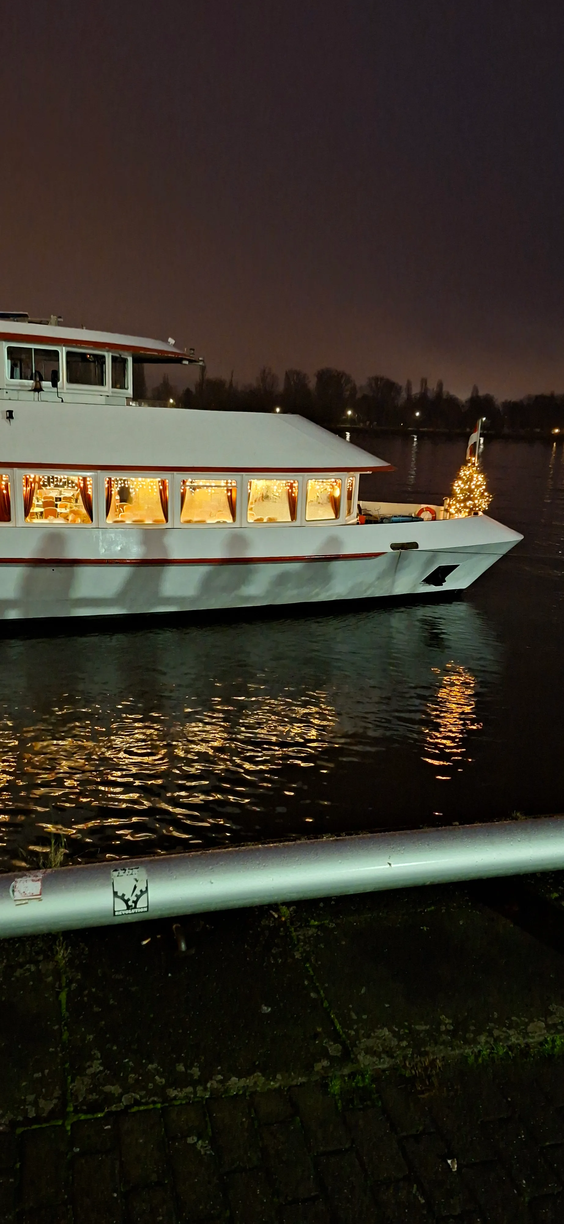 Geschmücktes Boot auf Fluss bei Nacht.