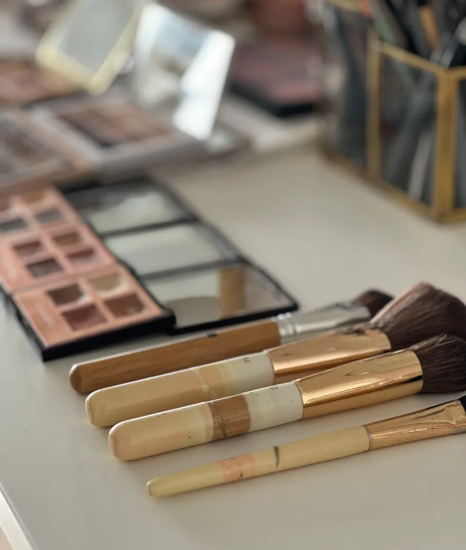 Makeup brushes and palettes on a table.