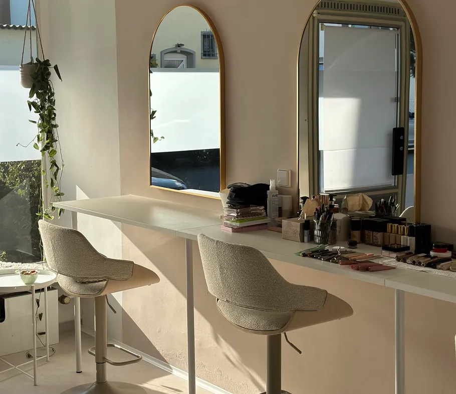 Makeup station with mirrors and chairs.