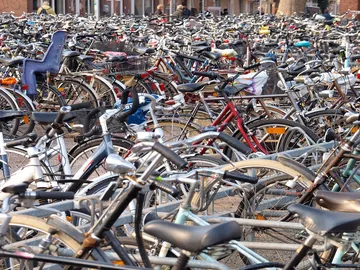 Hundreds of thousands of bicycles are parked close together in the city.