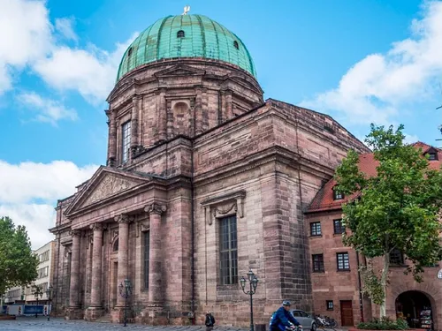 Large church buildings with dome and surrounding trees.