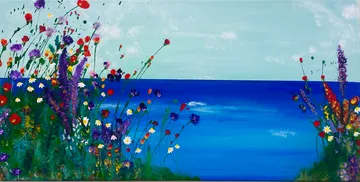 Colorful flowers along a calm blue sea.