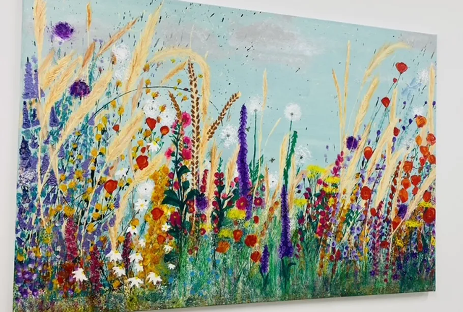 Colorful wildflowers painted on a canvas.