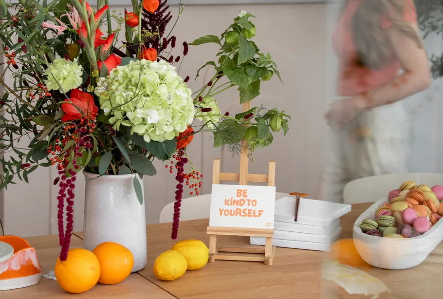 Flowers and fruits on a wooden table.