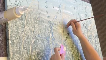Hands painting abstract landscape with brush.