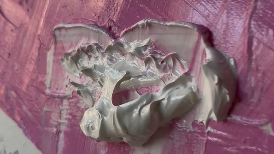 Thick paint texture on pink canvas.