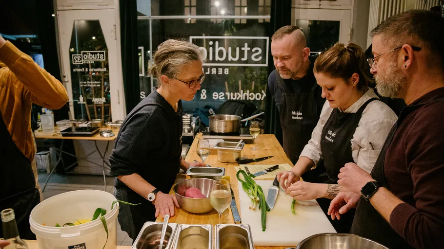 People preparing food in a cooking class.