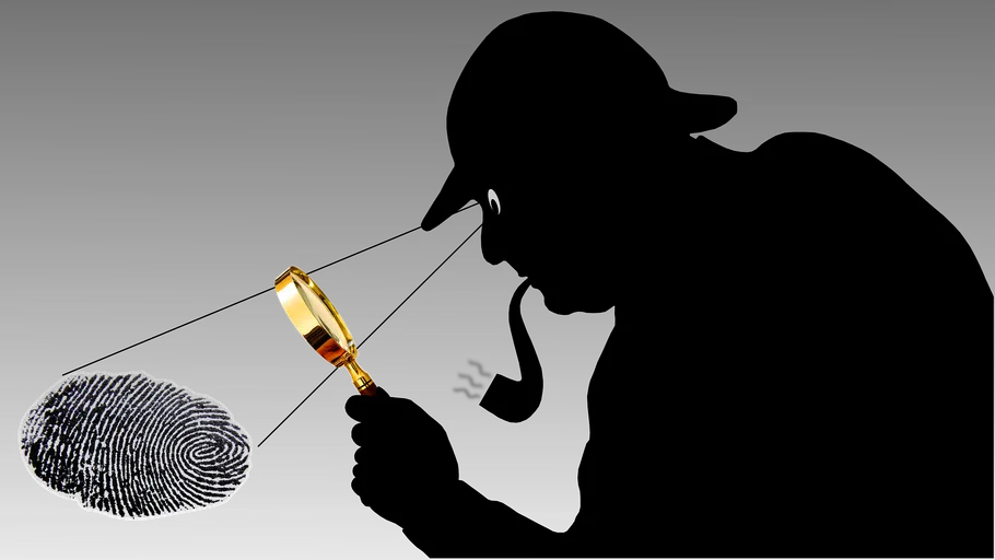 Silhouette of detective examining fingerprint.