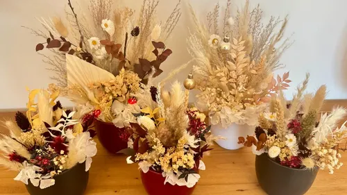 Dried flower arrangements on a wooden table.