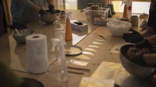 People working with materials on a table.