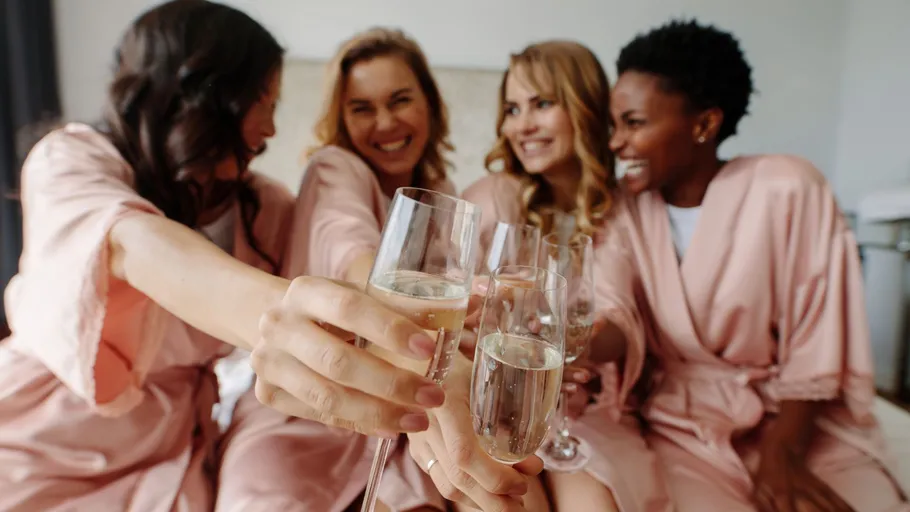 Four women toasting with champagne glasses.