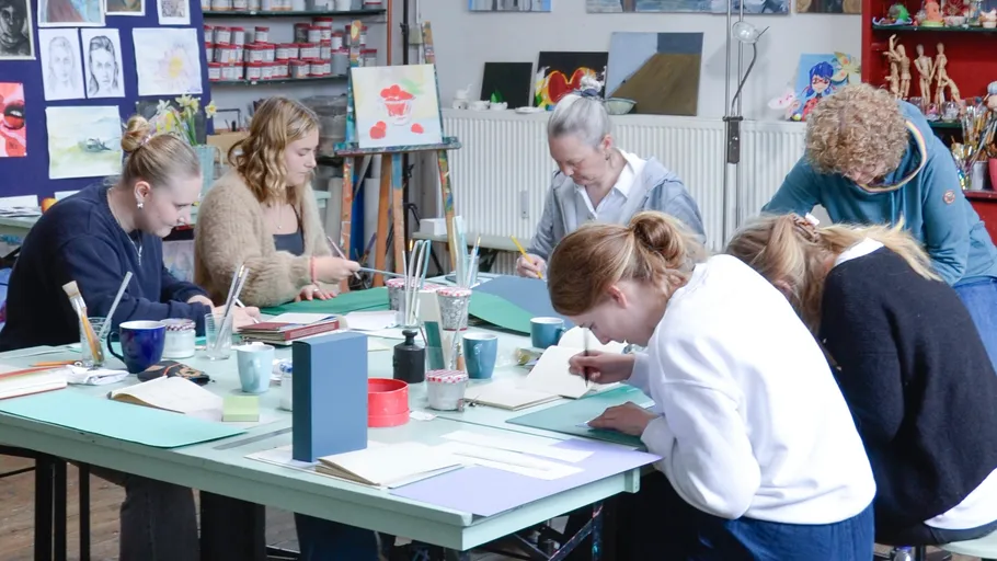 Group of people crafting at a table.