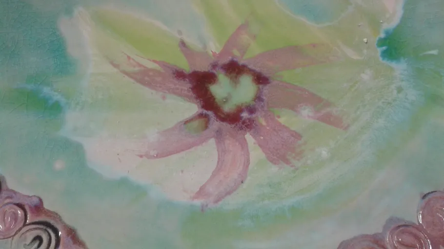 Abstract flower design on ceramic surface.
