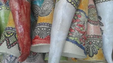 Colorful, intricately patterned ceramic vases displayed closely.