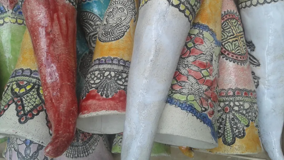 Colorful, intricately patterned ceramic vases displayed closely.