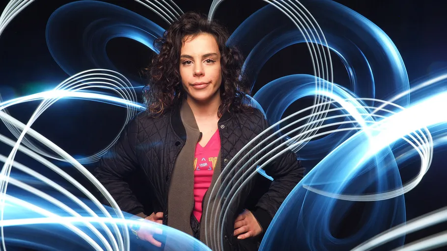 Person standing with glowing abstract lights.