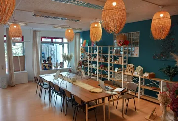 Creative workshop with wooden tables and shelves.