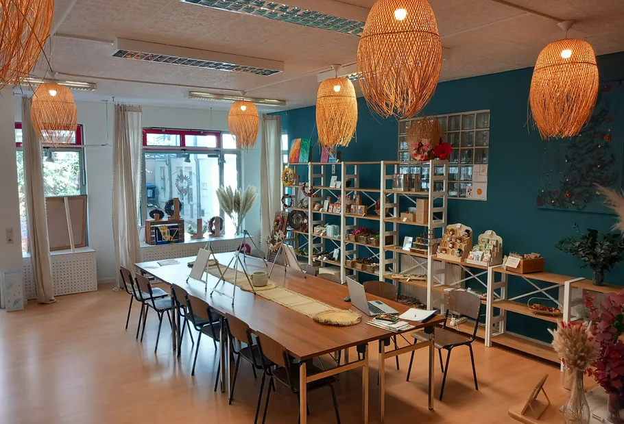 Kreativwerkstatt mit Holztischen und Regalen.