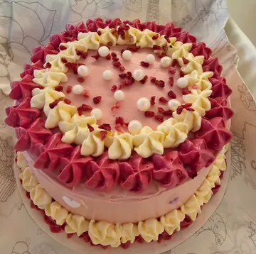 Decorated cake with red and yellow frosting.