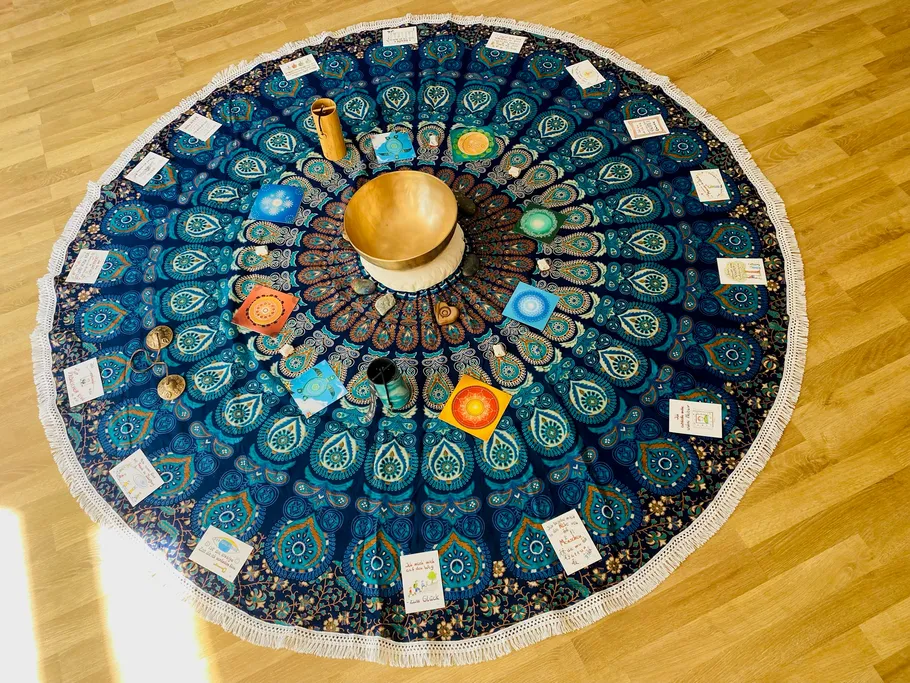 Mandala cloth with objects in circle formation.