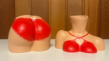 Two body-shaped pottery pieces, red lingerie.