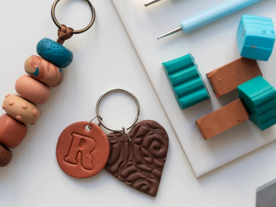 Clay keychains and tools on white surface.