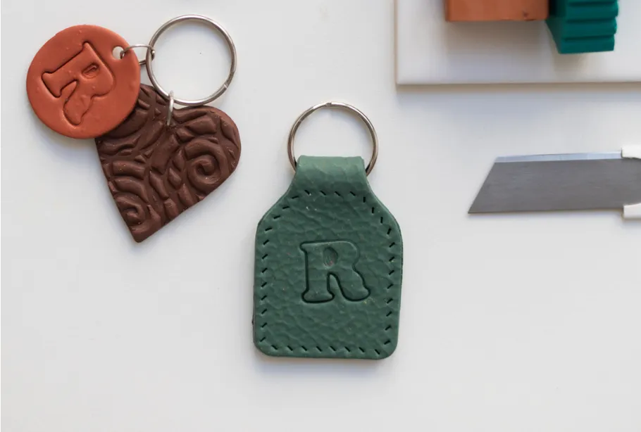 Keychains with letter 'R', crafting tools nearby.