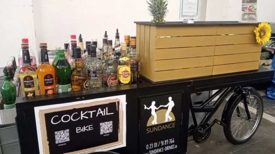 Bicycle bar with assorted liquor bottles displayed.