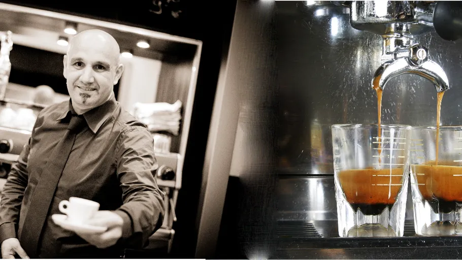 Barista serves espresso in coffee shop.