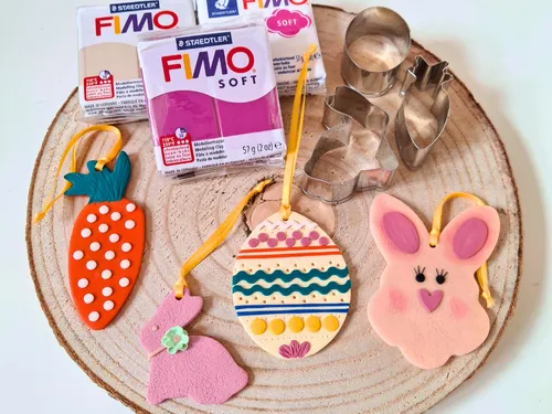 Clay crafts and tools on a wooden surface.