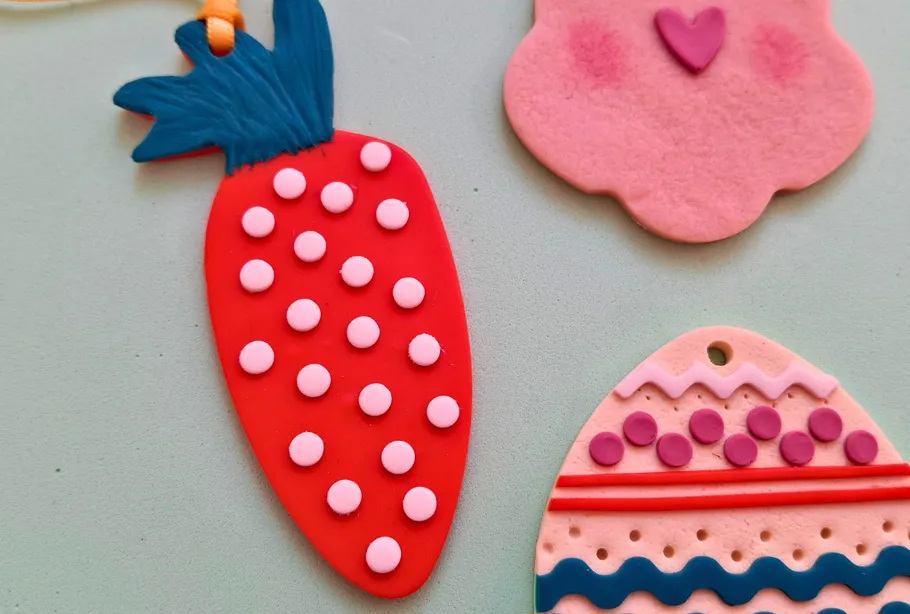 Colorful clay ornaments on a light surface.